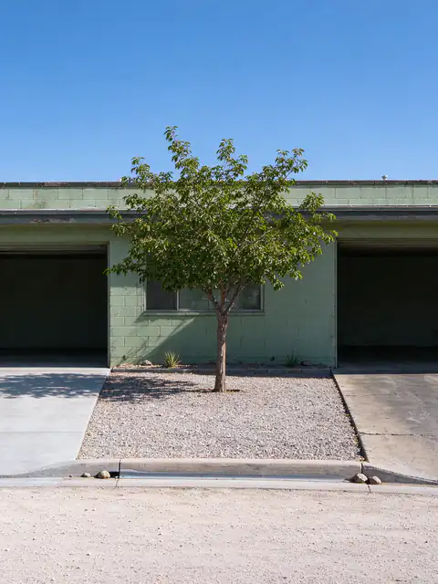 1960s duplex in Tempe with two side-by-side concrete driveways, one newly replaced