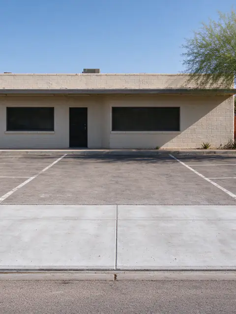 Small central Phoenix commercial lot with a newly replaced concrete driveway apron beside an older bungalow